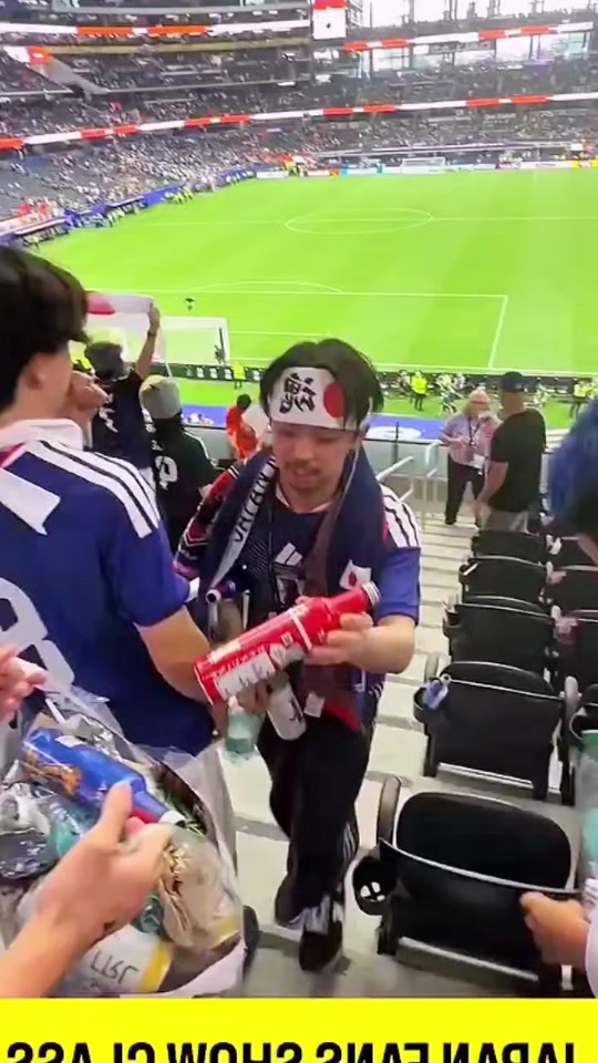 After cheering their team on to a draw, Japan fans clean up the stan...
